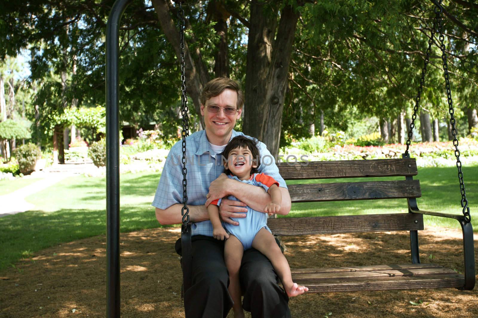 Father and child swinging