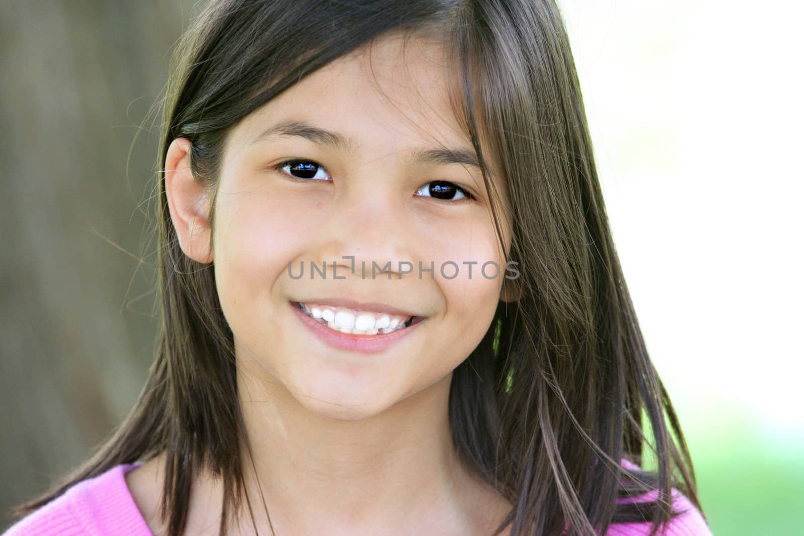 Beautiful little girl smiling outdoors