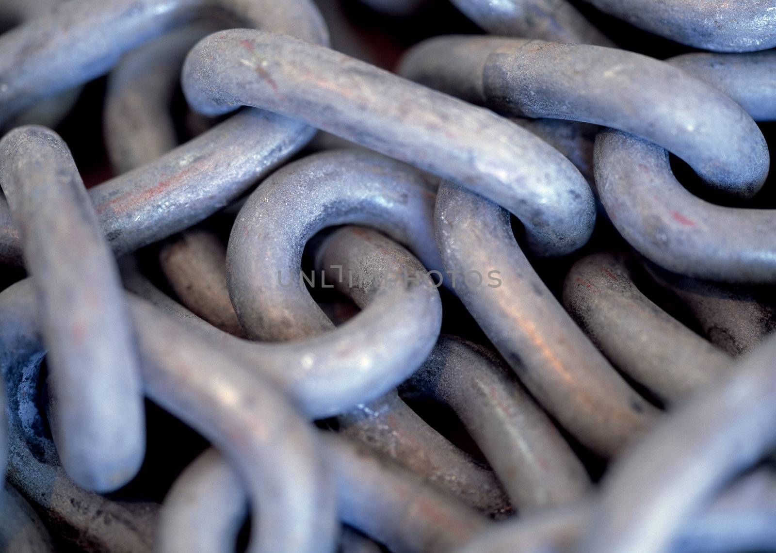 Very shallow depth-of-field image of a pile of chain.
