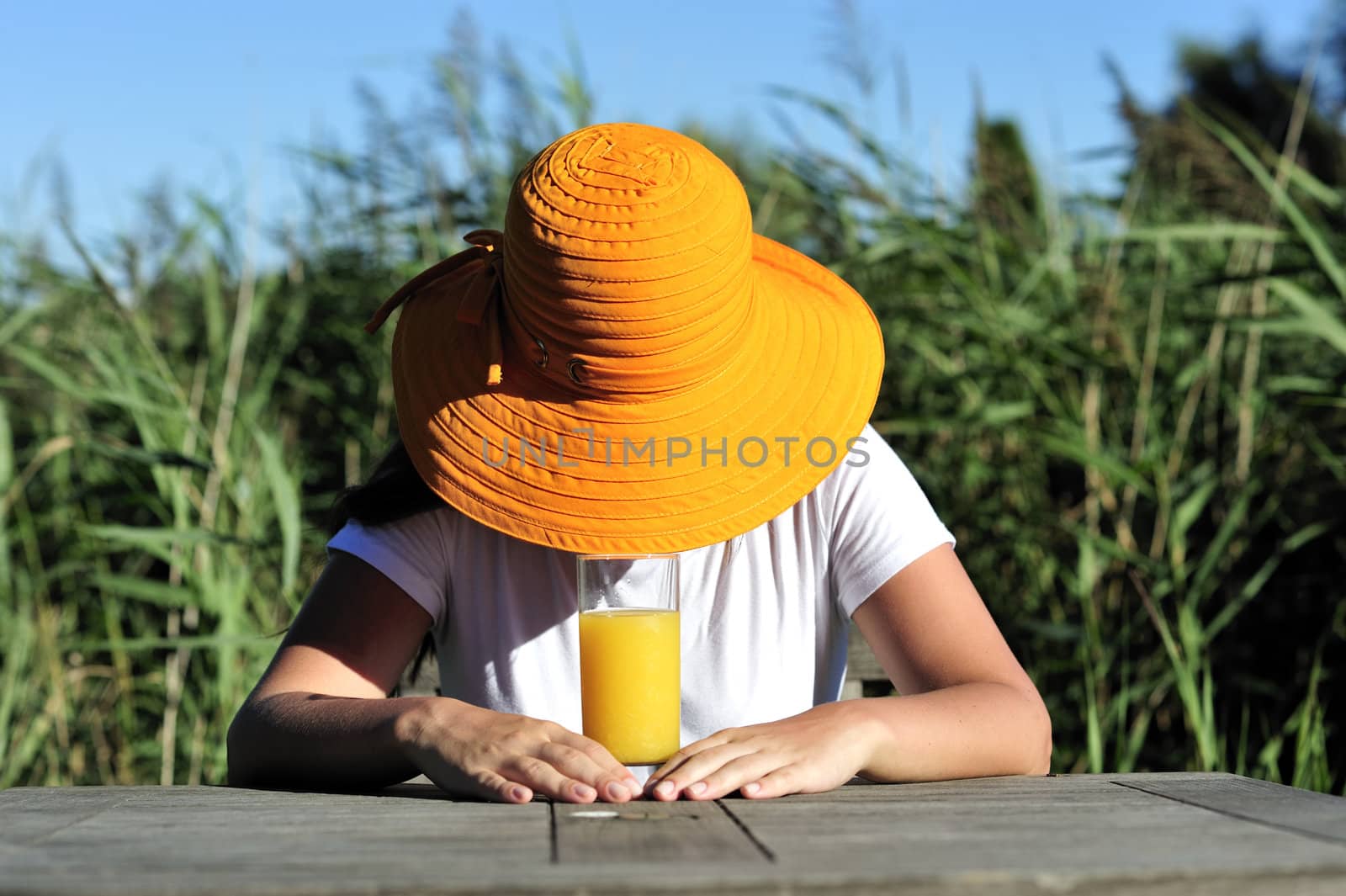 Woman drinking her juice during the summer holidays.