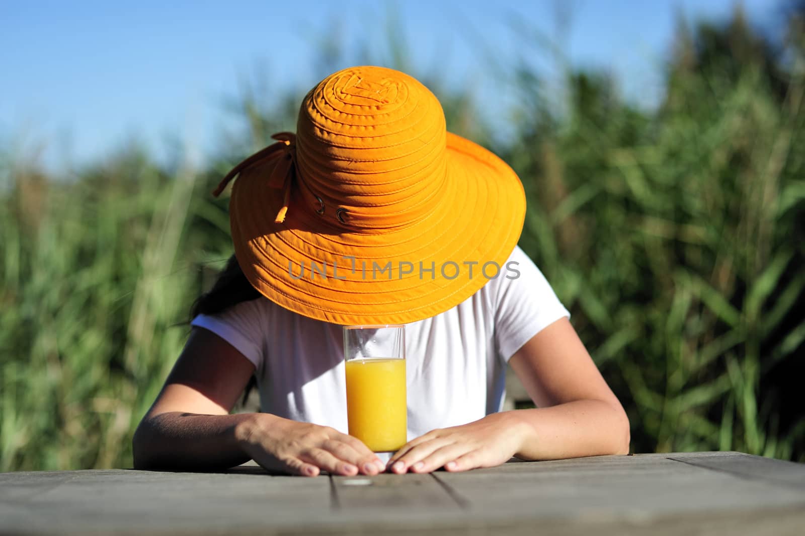 Woman drinking her juice during the summer holidays.