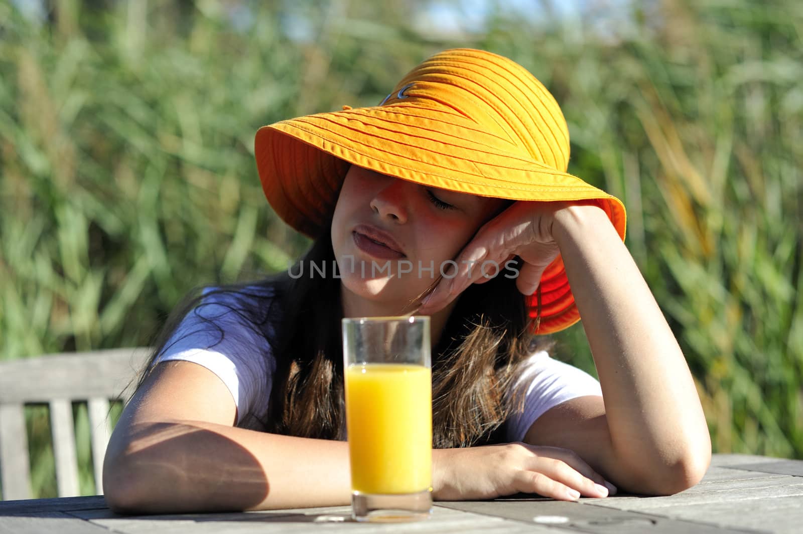 Woman drinking her juice during the summer holidays.