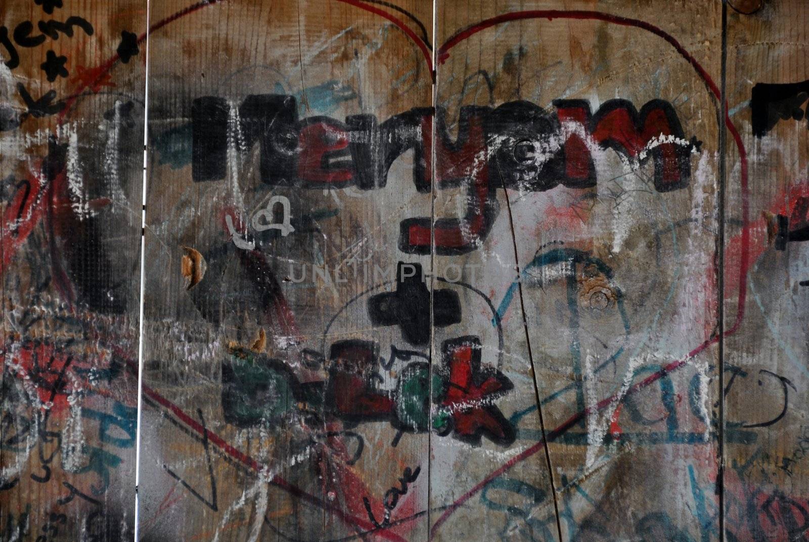 Colourful I love you scribbles written on wooden playground wall