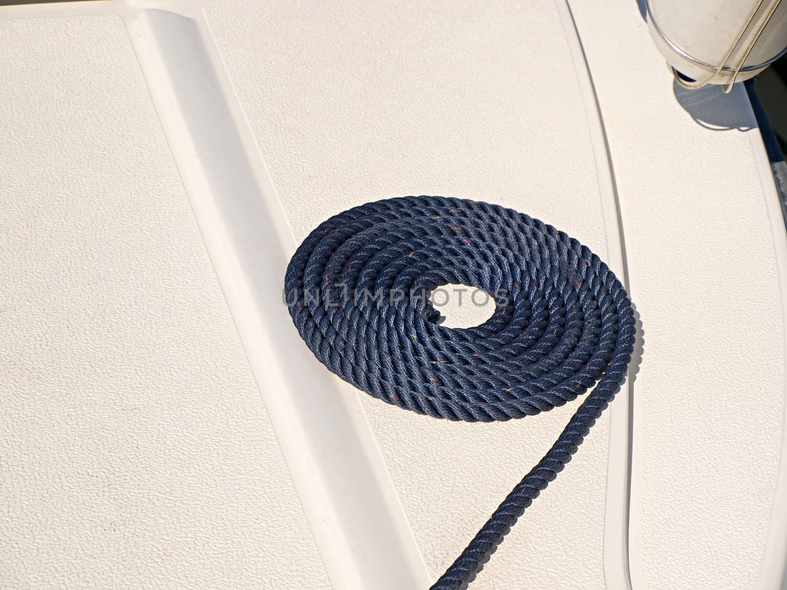 Coiled nautical rope on a deck of a sail yacht