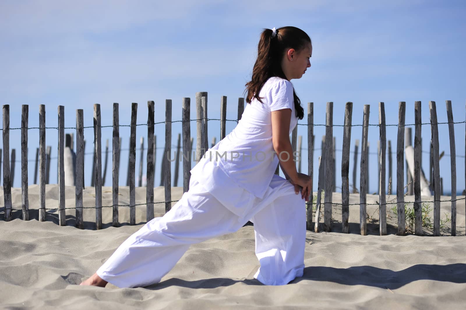 Woman doing stretching on the beach