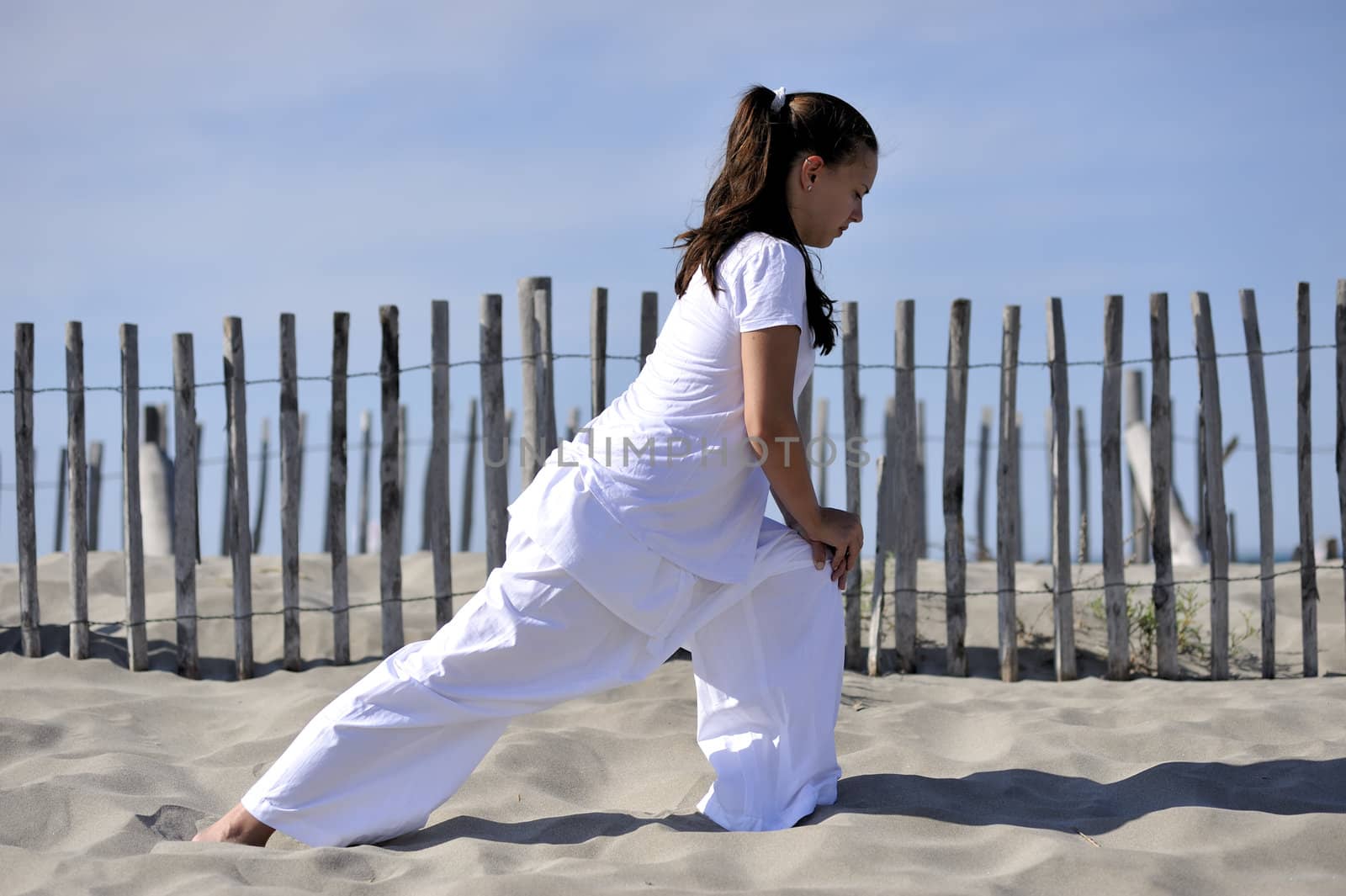 Woman doing stretching on the beach