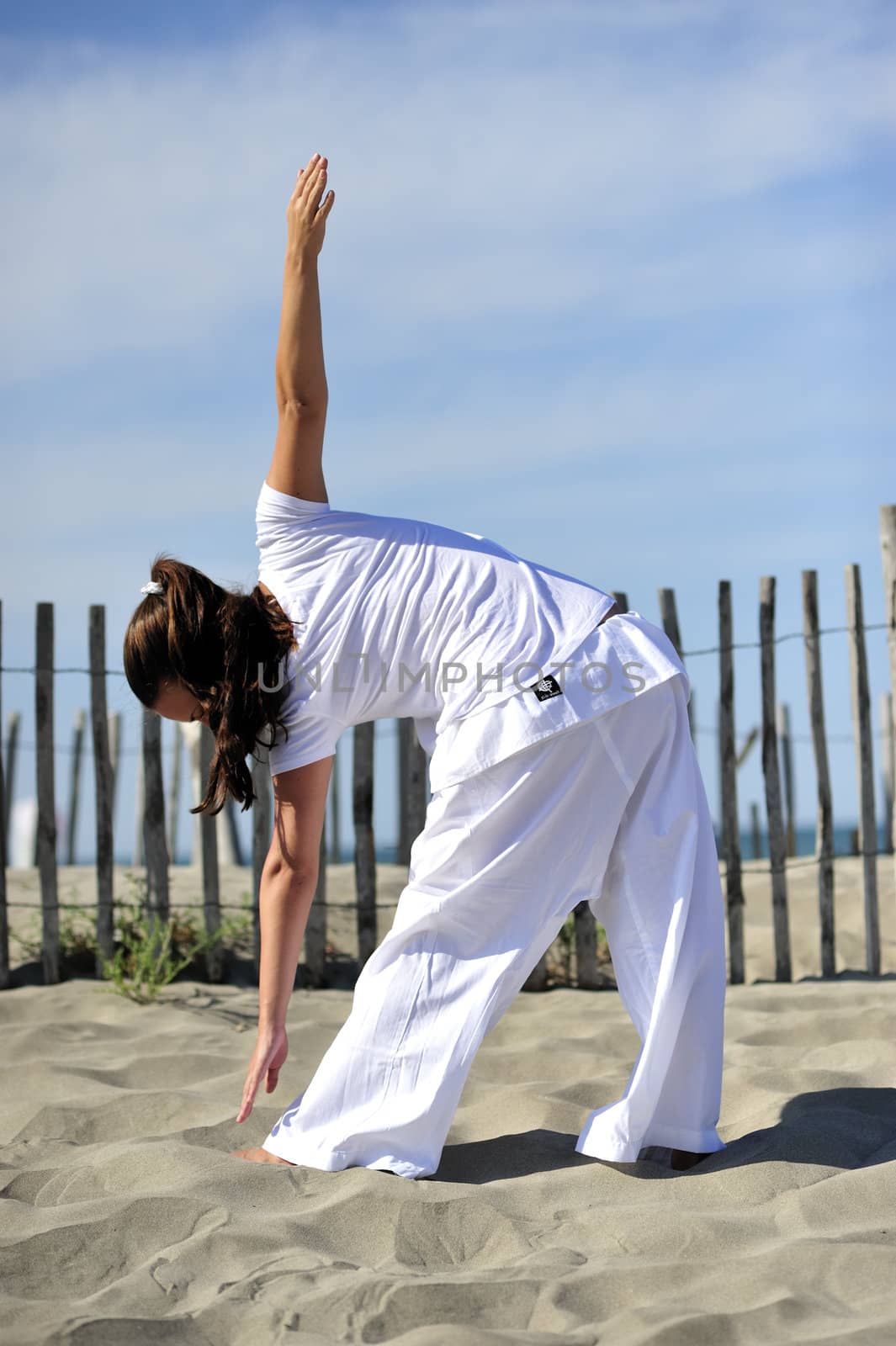 Woman doing stretching on the beach