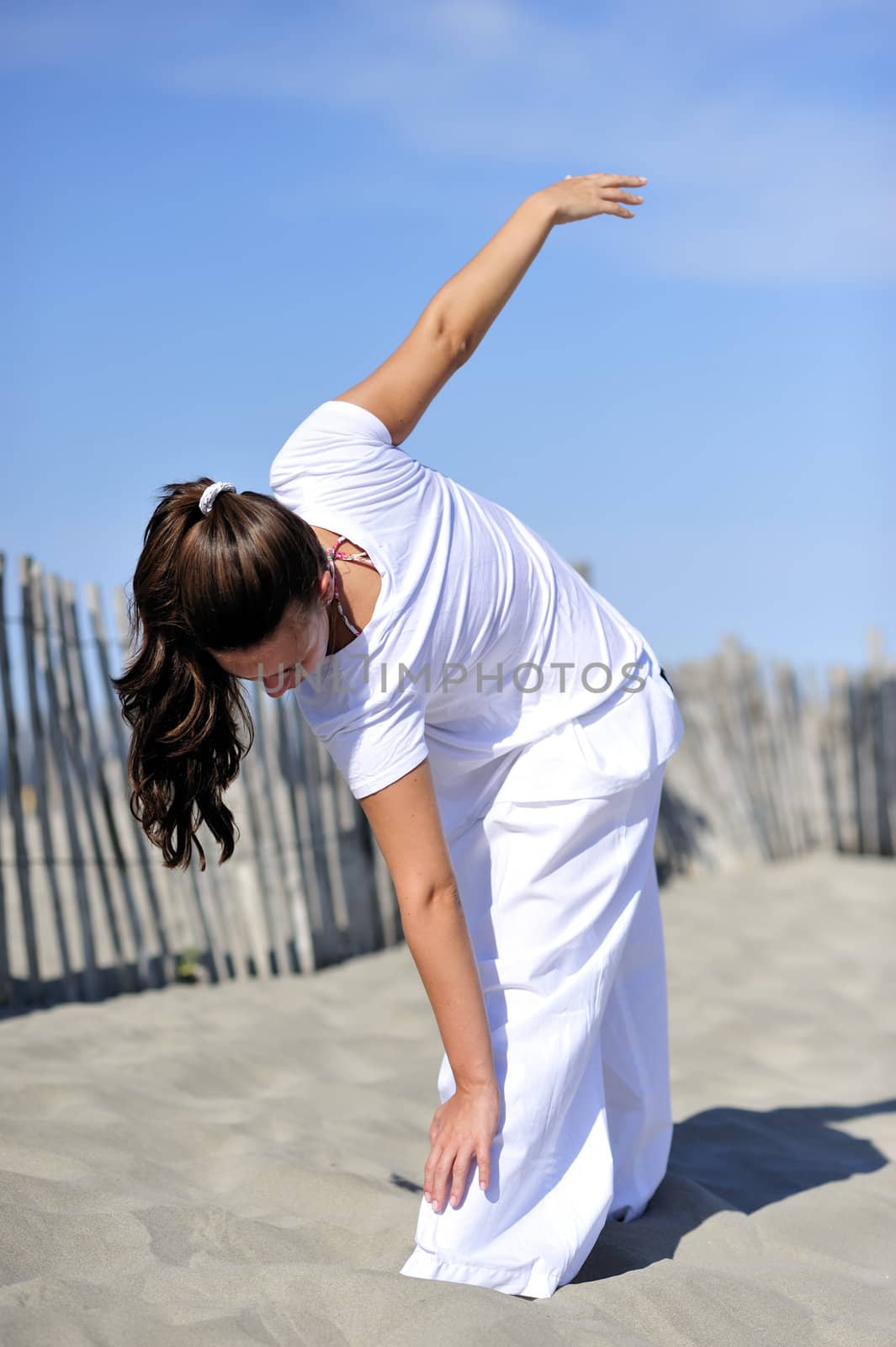 Woman doing stretching on the beach