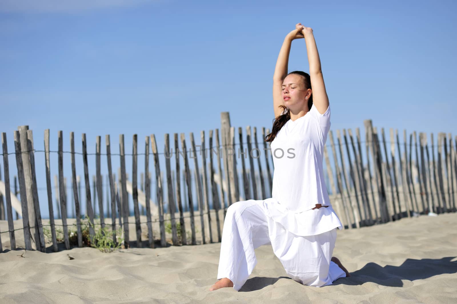 Woman doing stretching on the beach