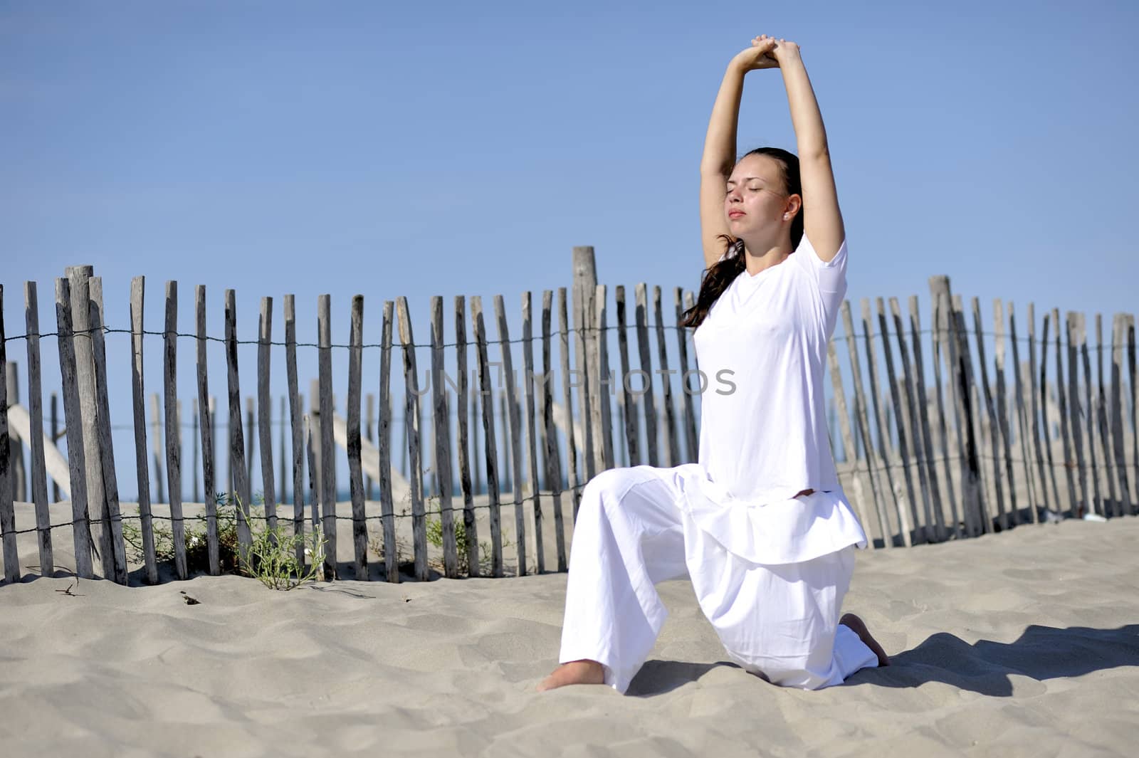 Woman doing stretching on the beach