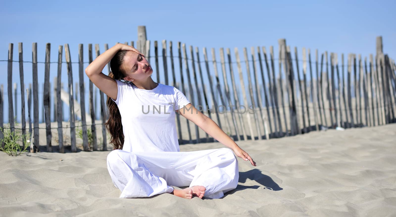 Woman doing stretching on the beach