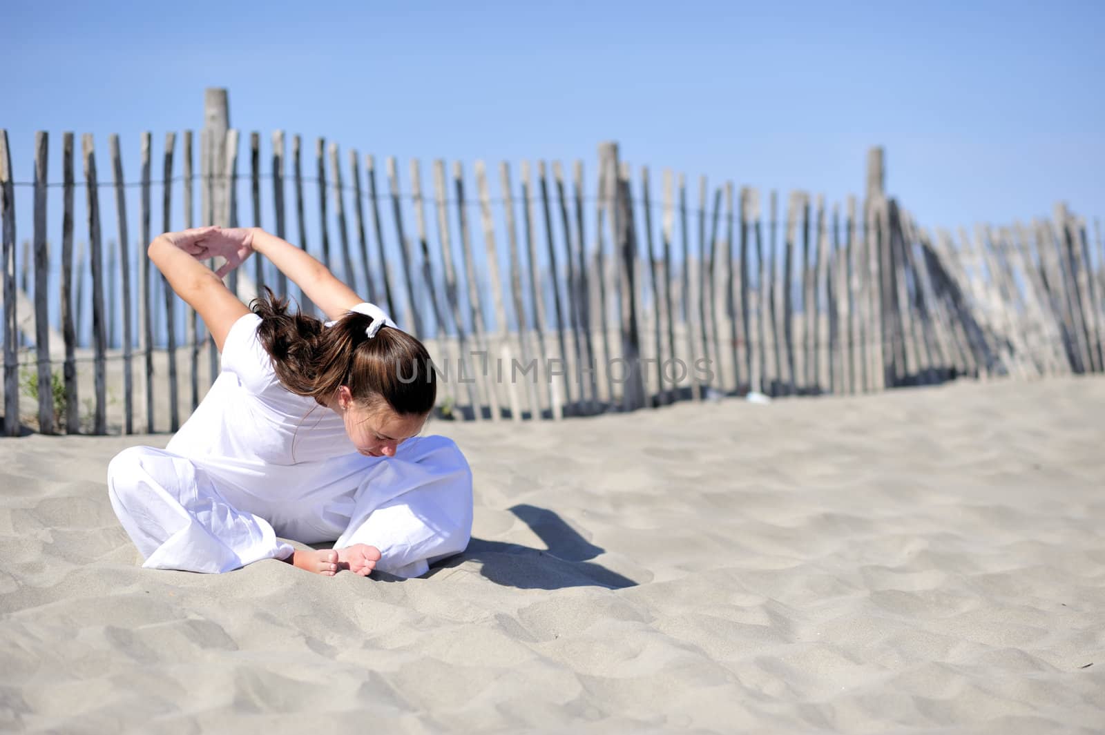 Woman doing stretching on the beach