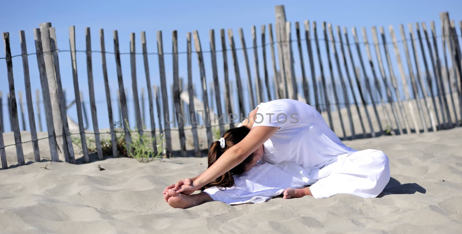 Woman doing stretching on the beach