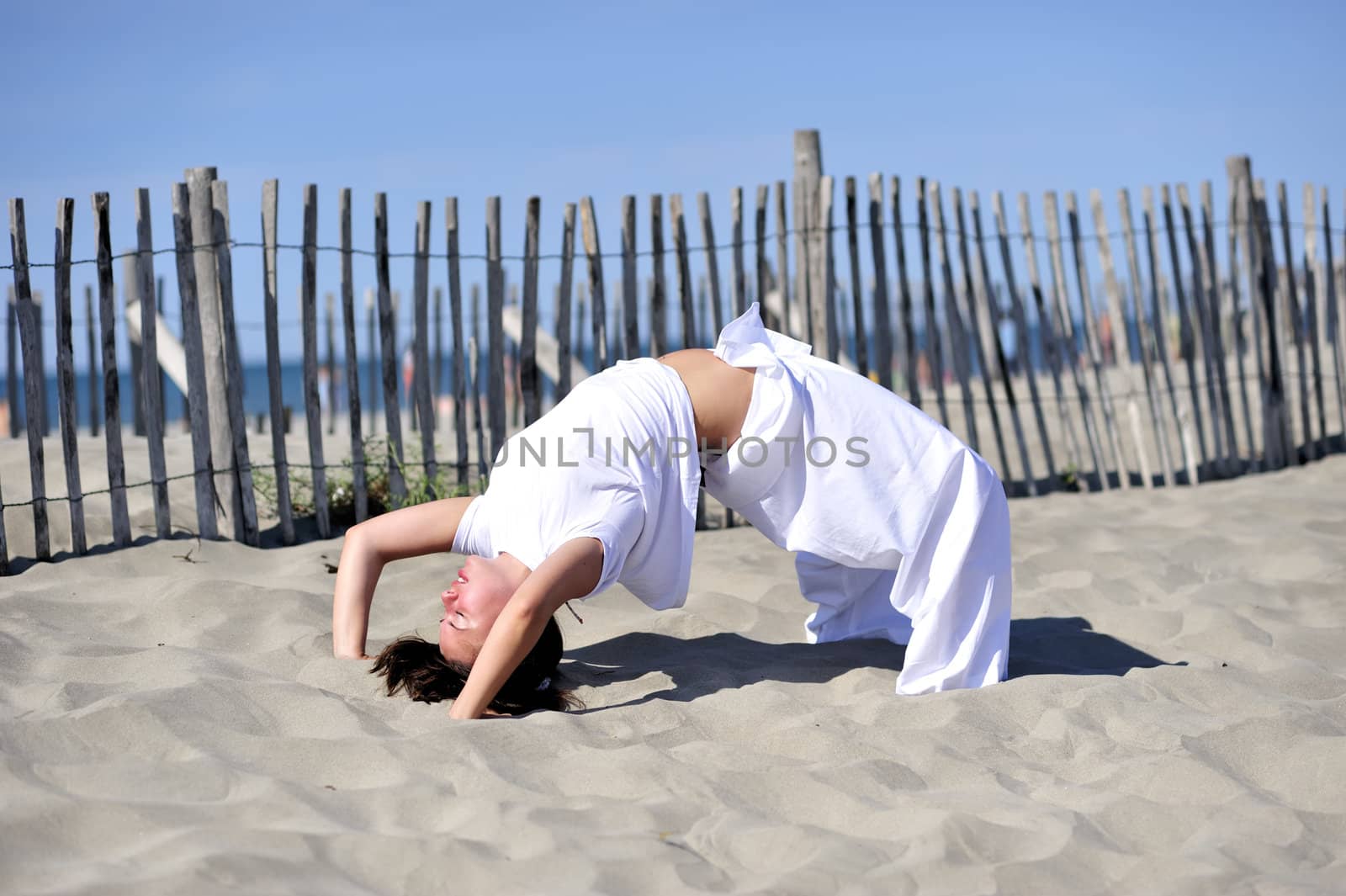 Woman doing stretching on the beach