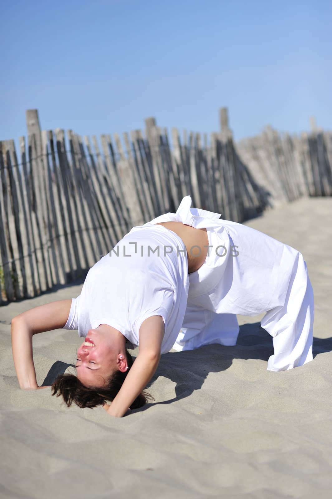 Woman doing stretching on the beach