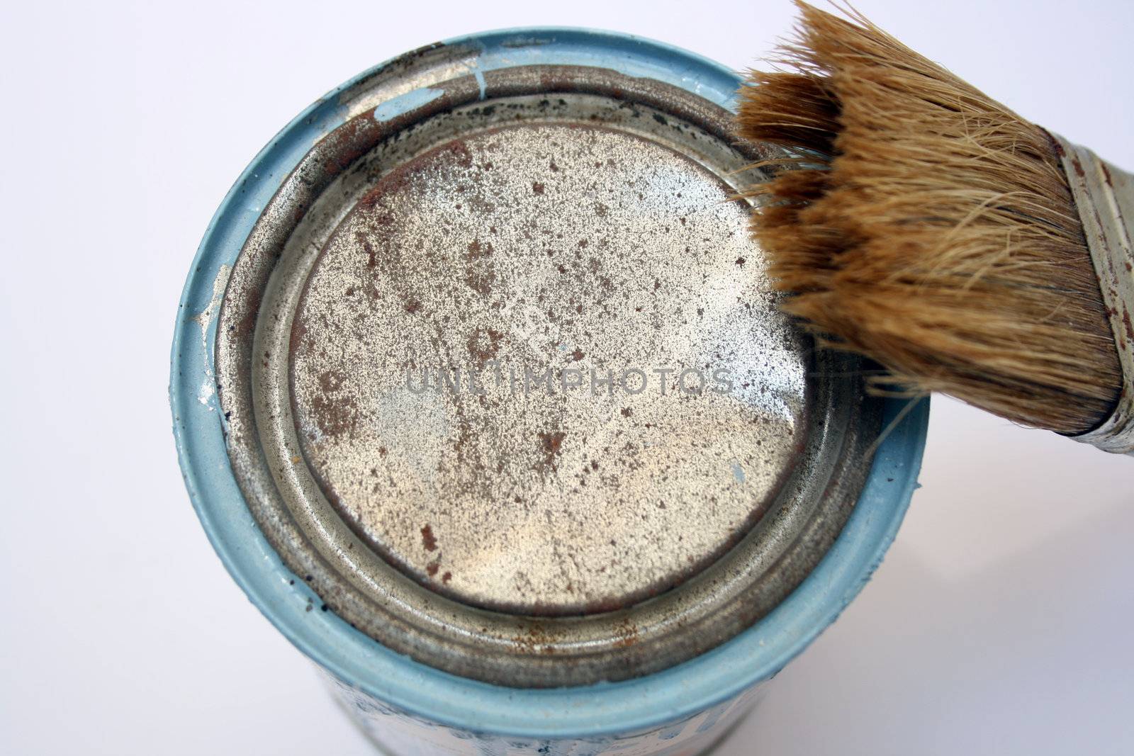 Paint can and brush after being used