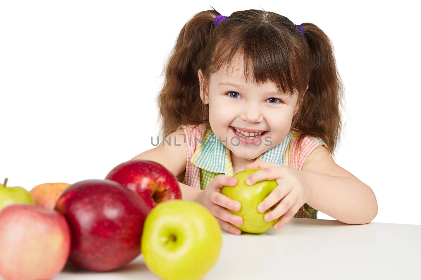 Happy child with apples - sources of vitamins on white background