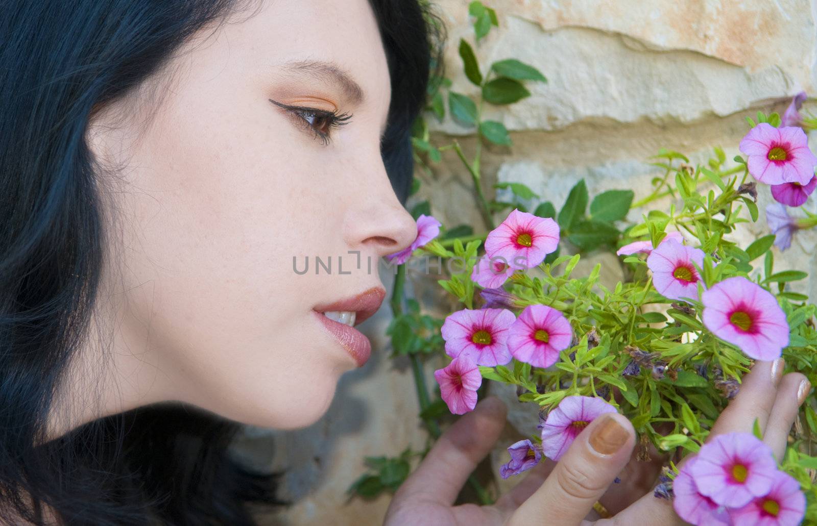 The girl has bent over a flower 