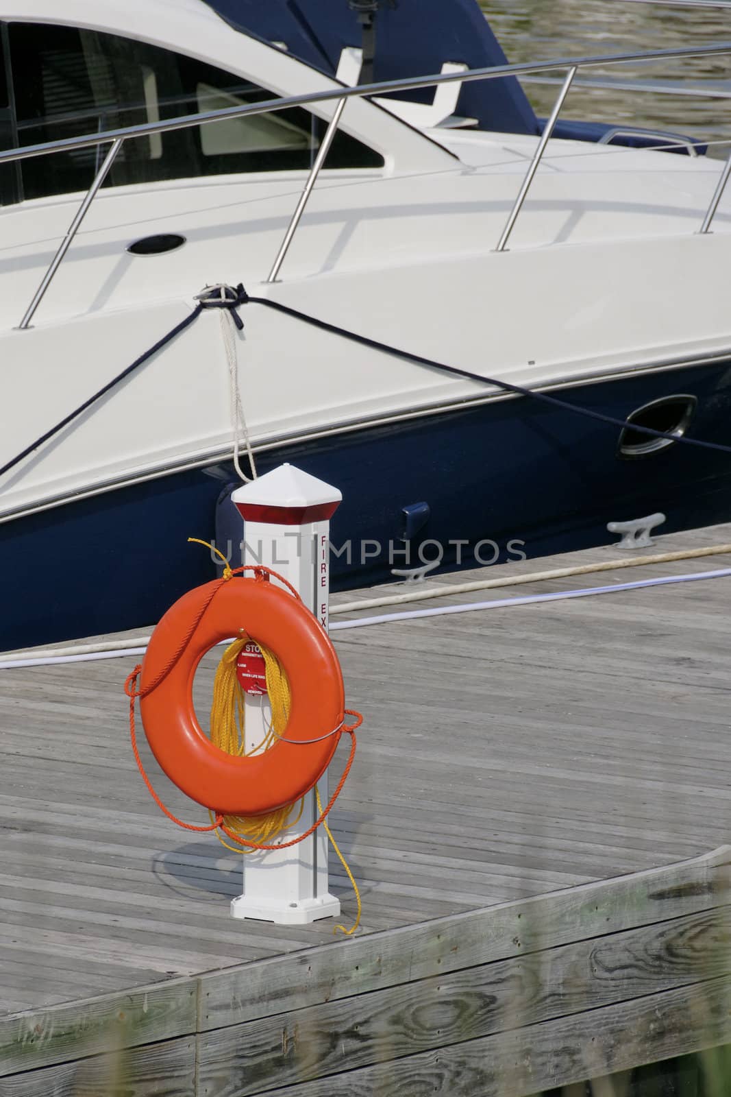 Orange life ring station on dock.