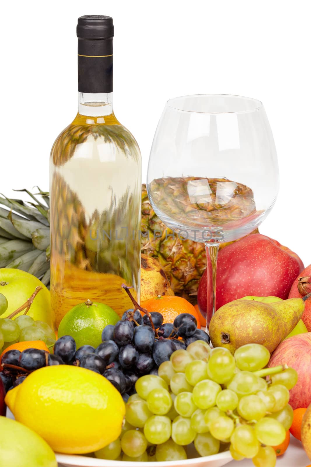 Still life - a bottle of wine, glass and tropical fruit on white