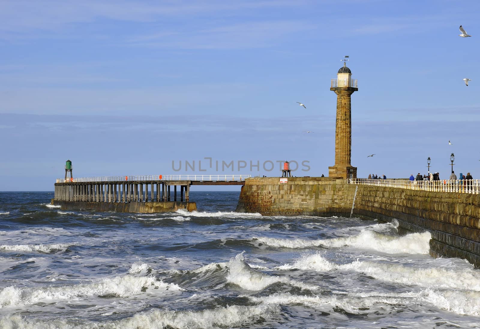 Postcard view of Whitby pier and lighthouse
