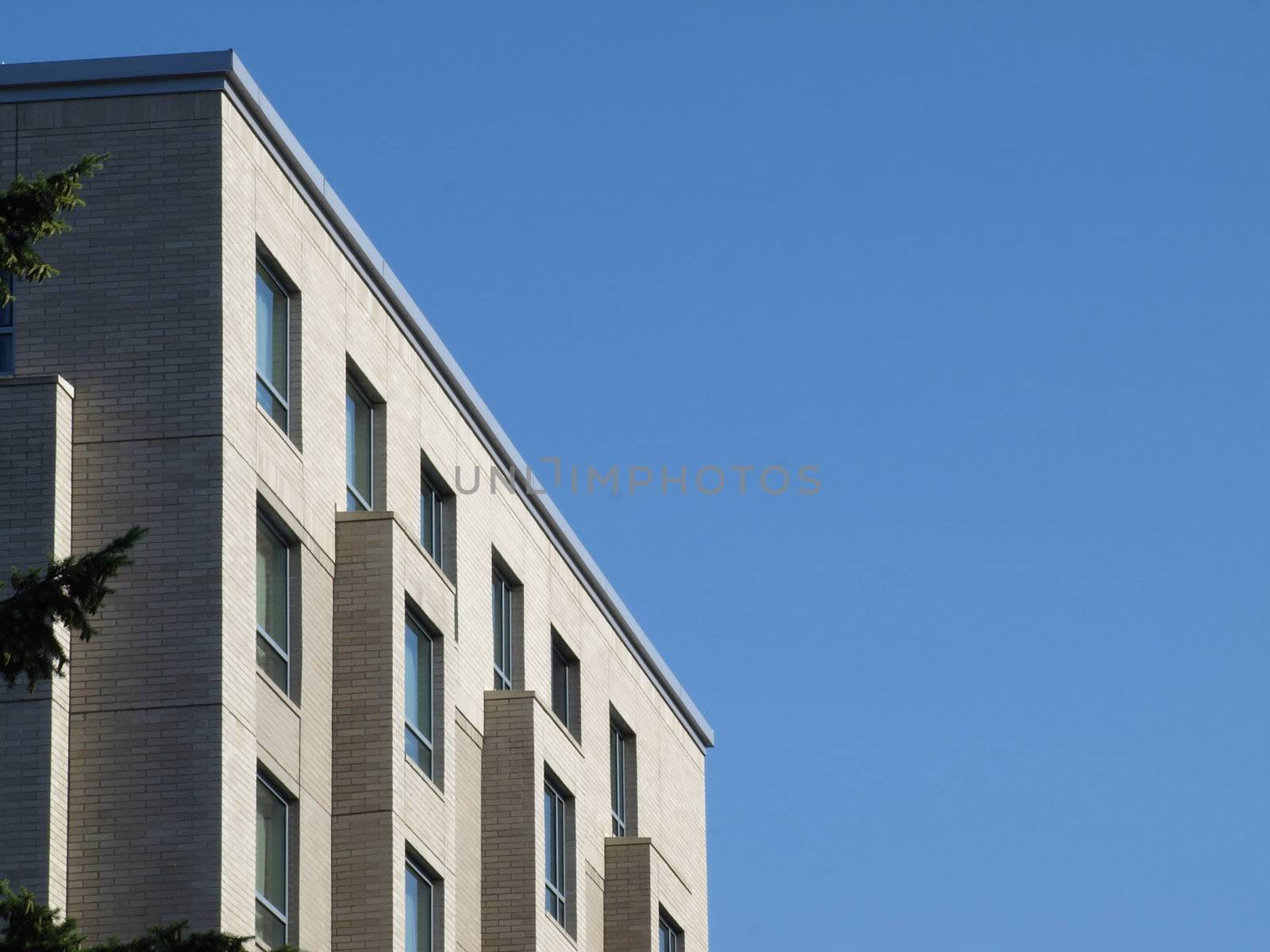 Top floors of a white building against a blue sky