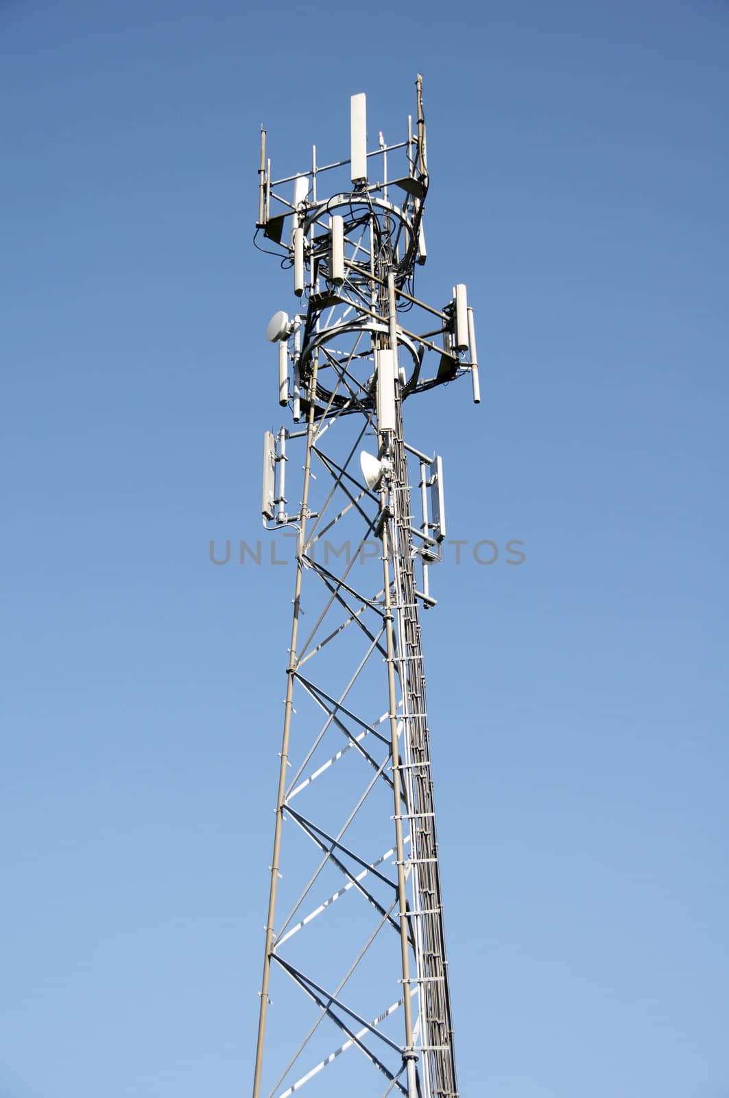 A phone mast against a clear blue sky