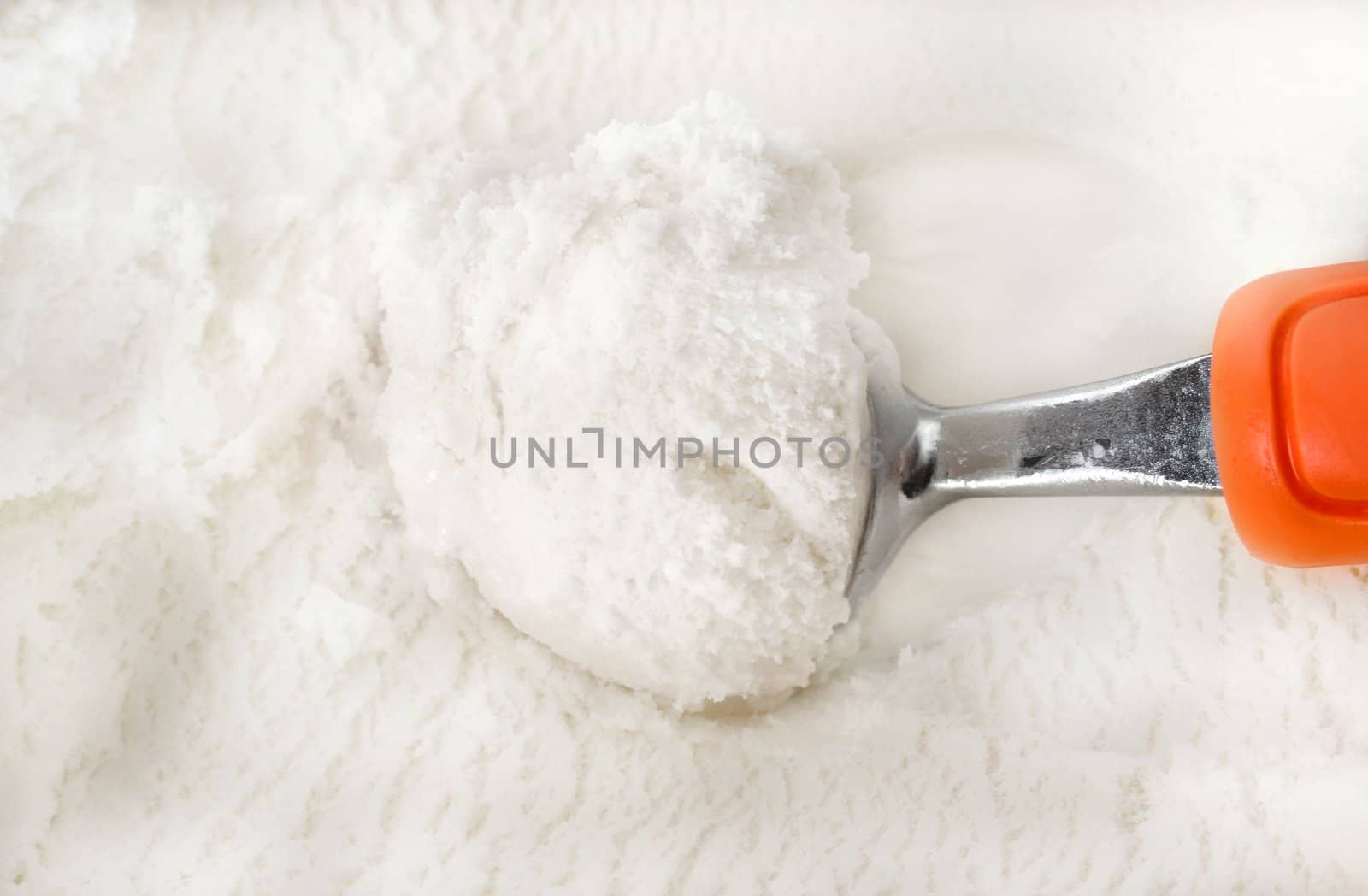 
Vanilla ice cream with serving scoop.  Macro with shallow dof.