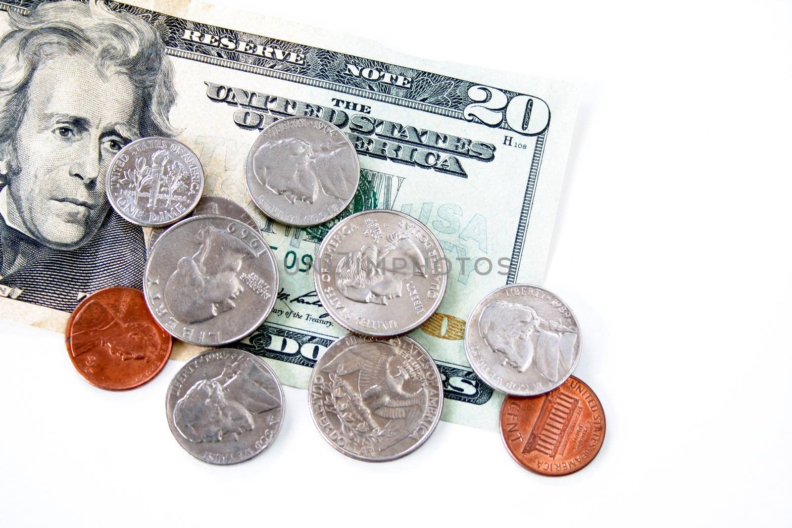 A twenty dollar bill and loose change isolated on a white background.