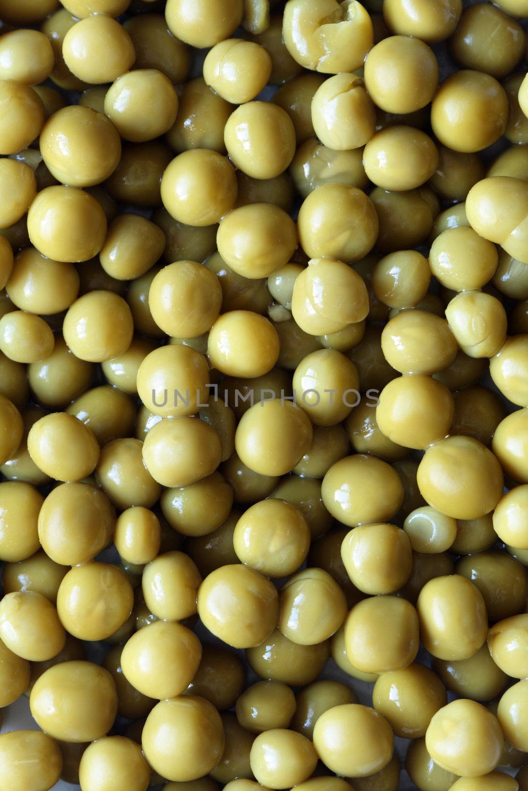 Background made from preserved green peas. Extreme closeup