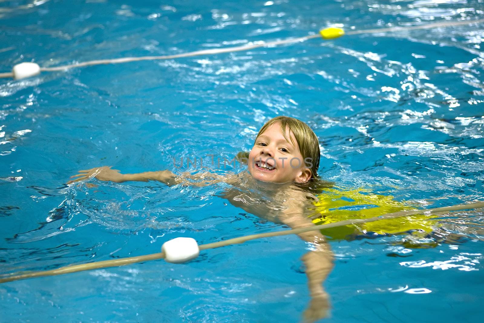 a boy is learning how to swim