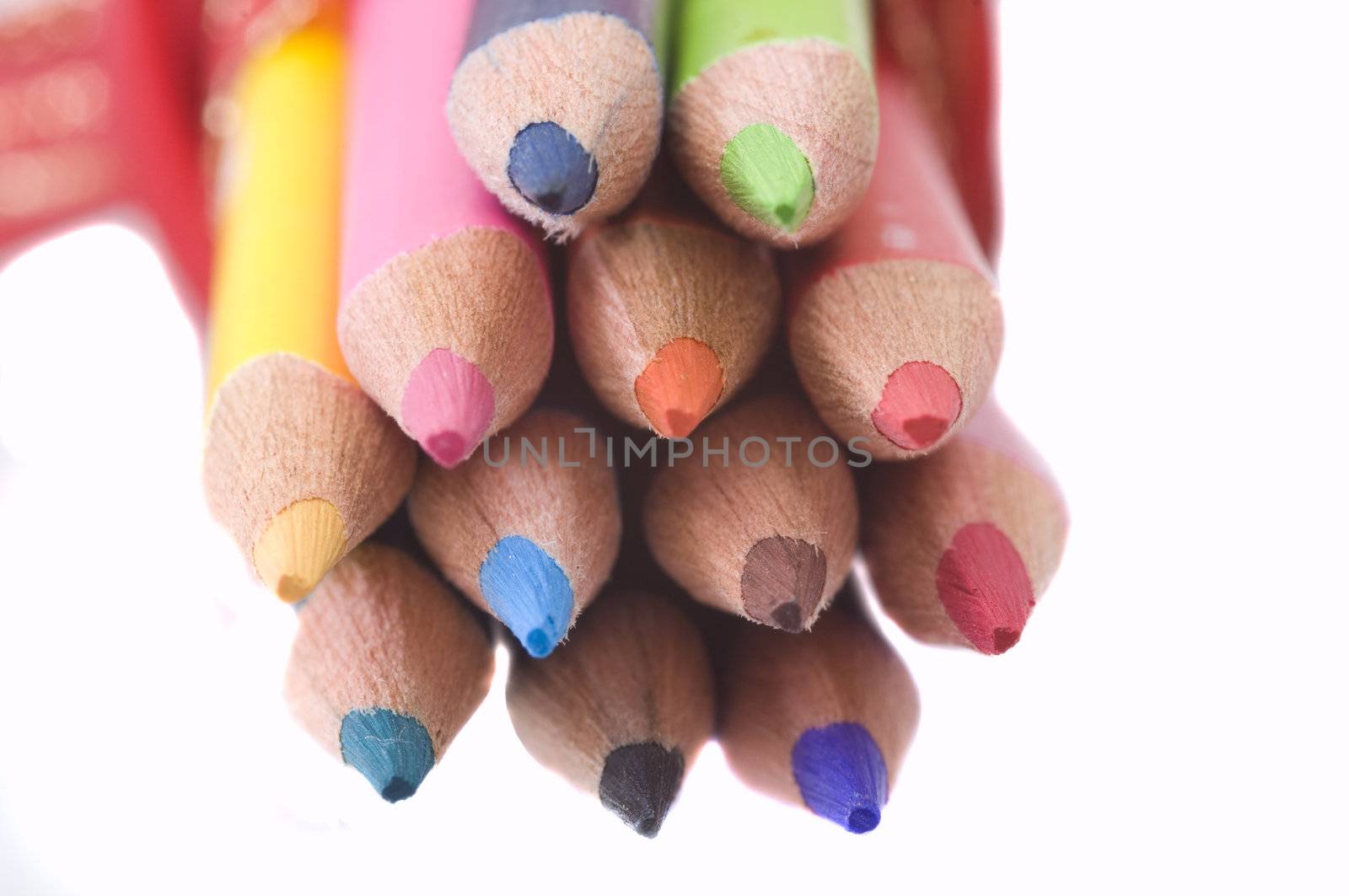 color pencils tied together, isolated on white background