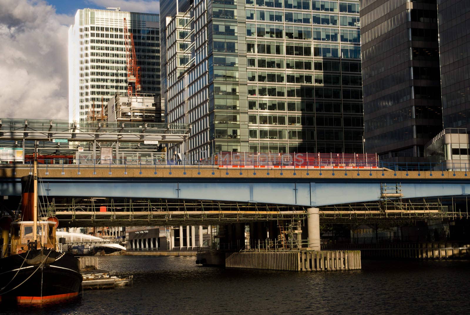 View of Canary Wharf station on the canal. London.