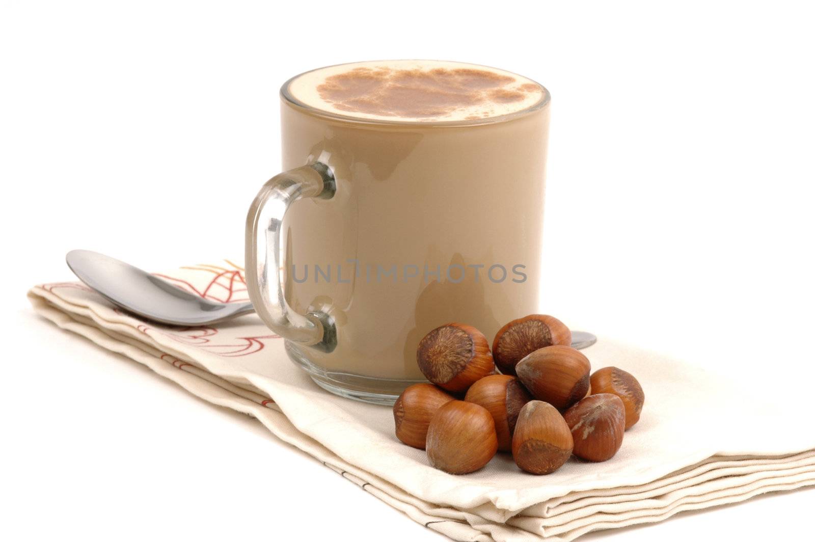 Cup of cappuccino with hazelnuts in the shell.