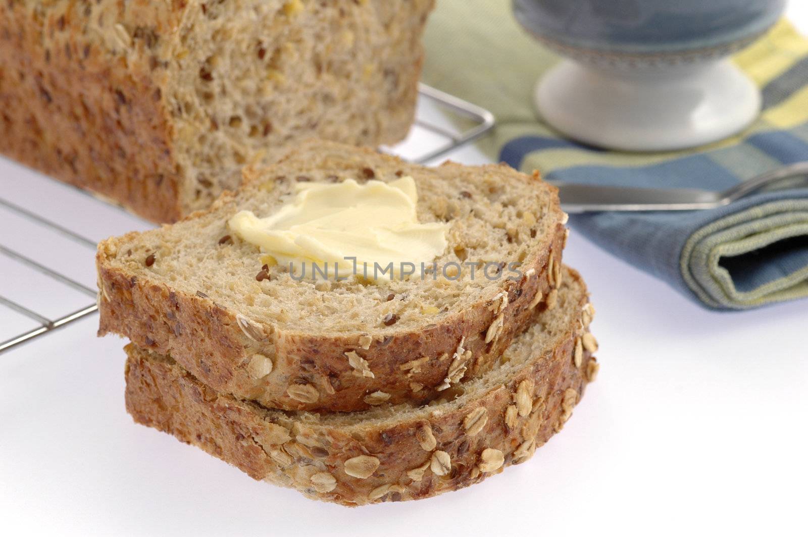 Slices of homemade hearty bread with butter.