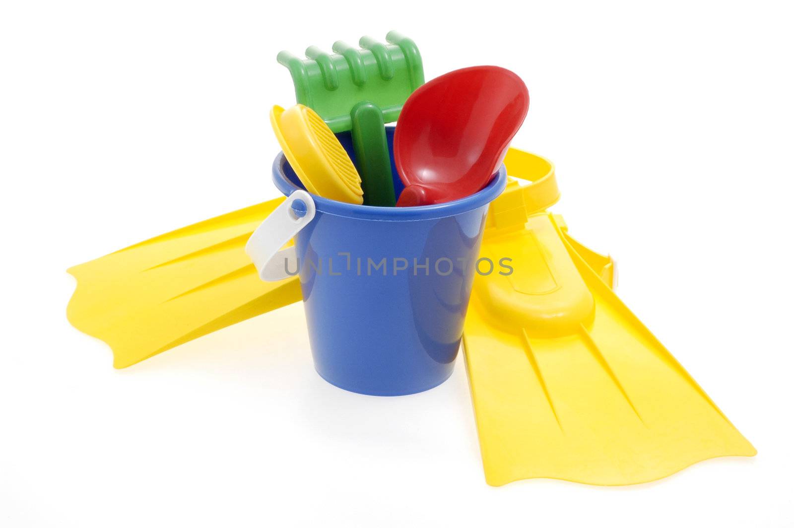 Assortment of colorful beach toys on a white background.