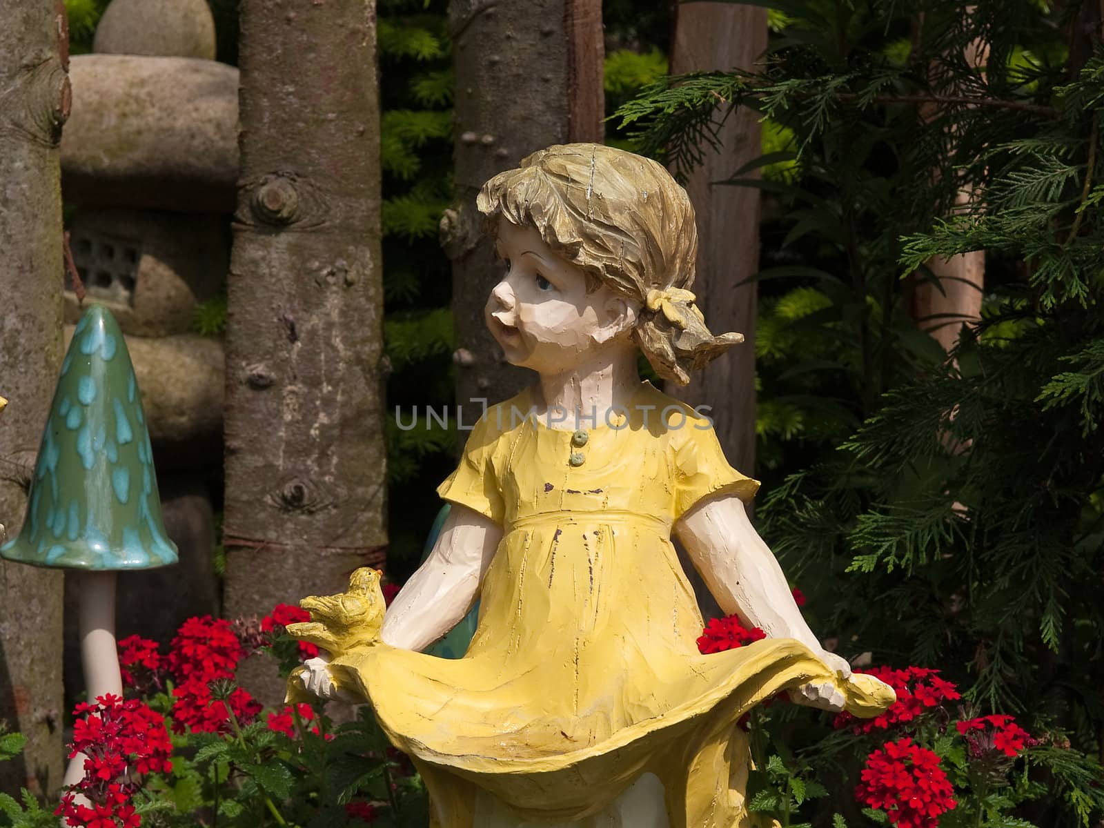 Garden gnome dwarf statue of a cute girl made from wood