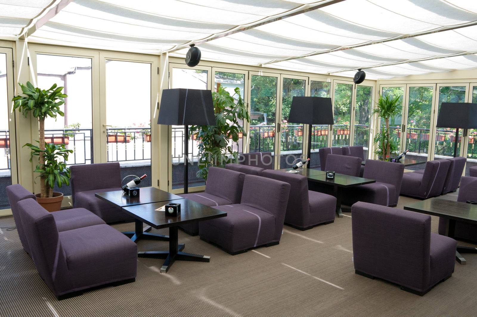 brightly lit restaurant interior with gray chairs