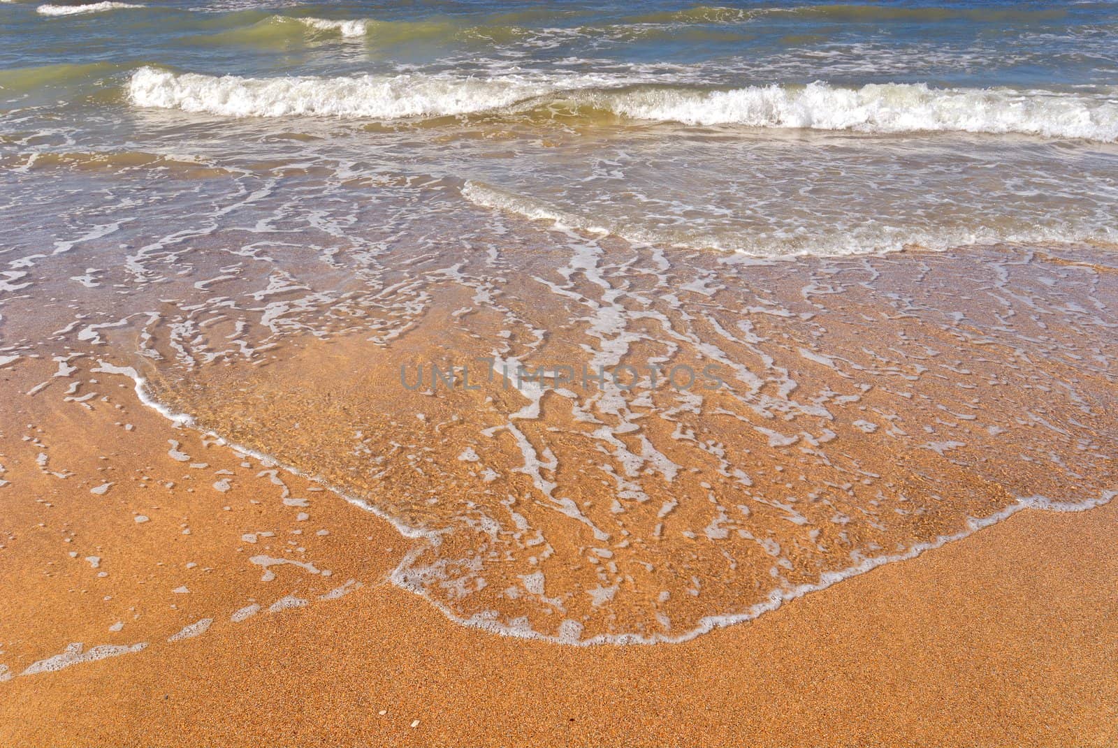 Golden beach with just some waves at the North Sea