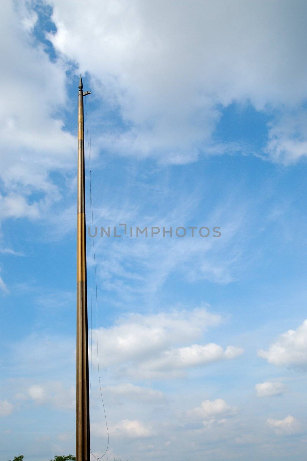 bare flagstaff against blue sky