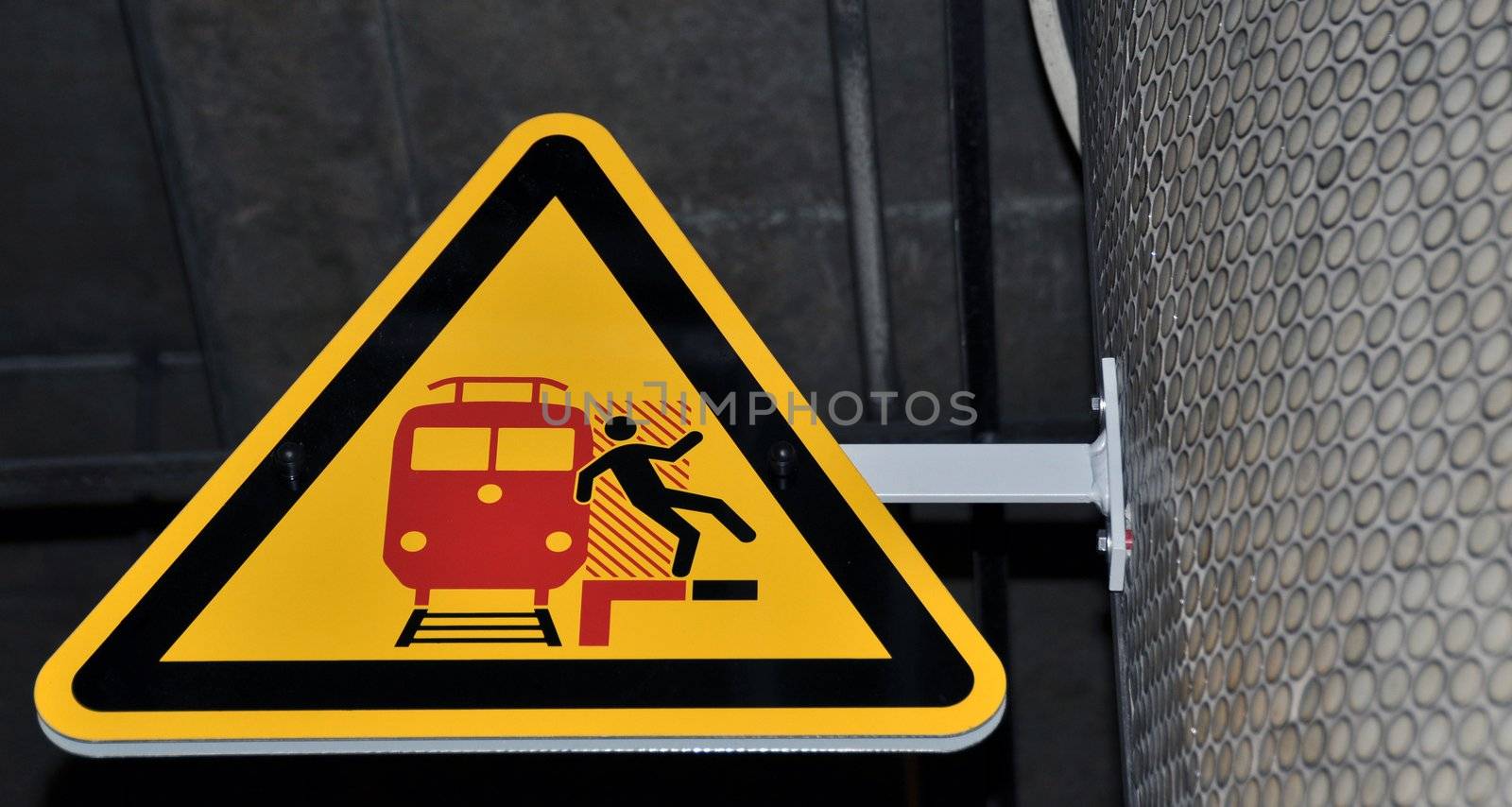 Sign on platform warning travellers of approaching trains