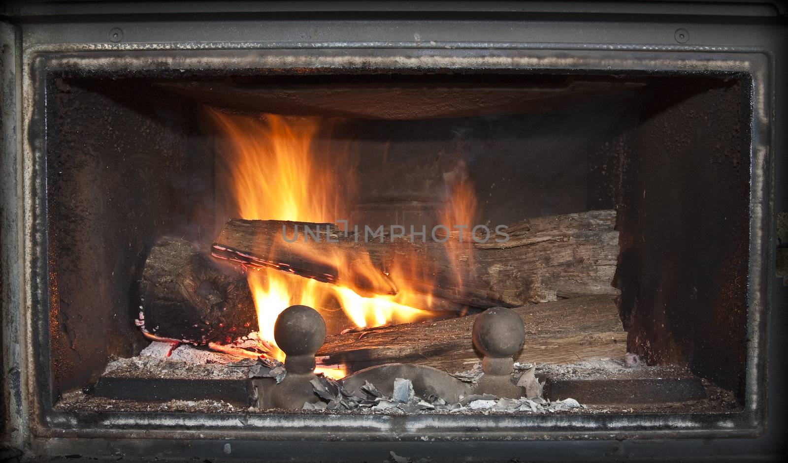 Close-up shot of a burning log in a fireplace.