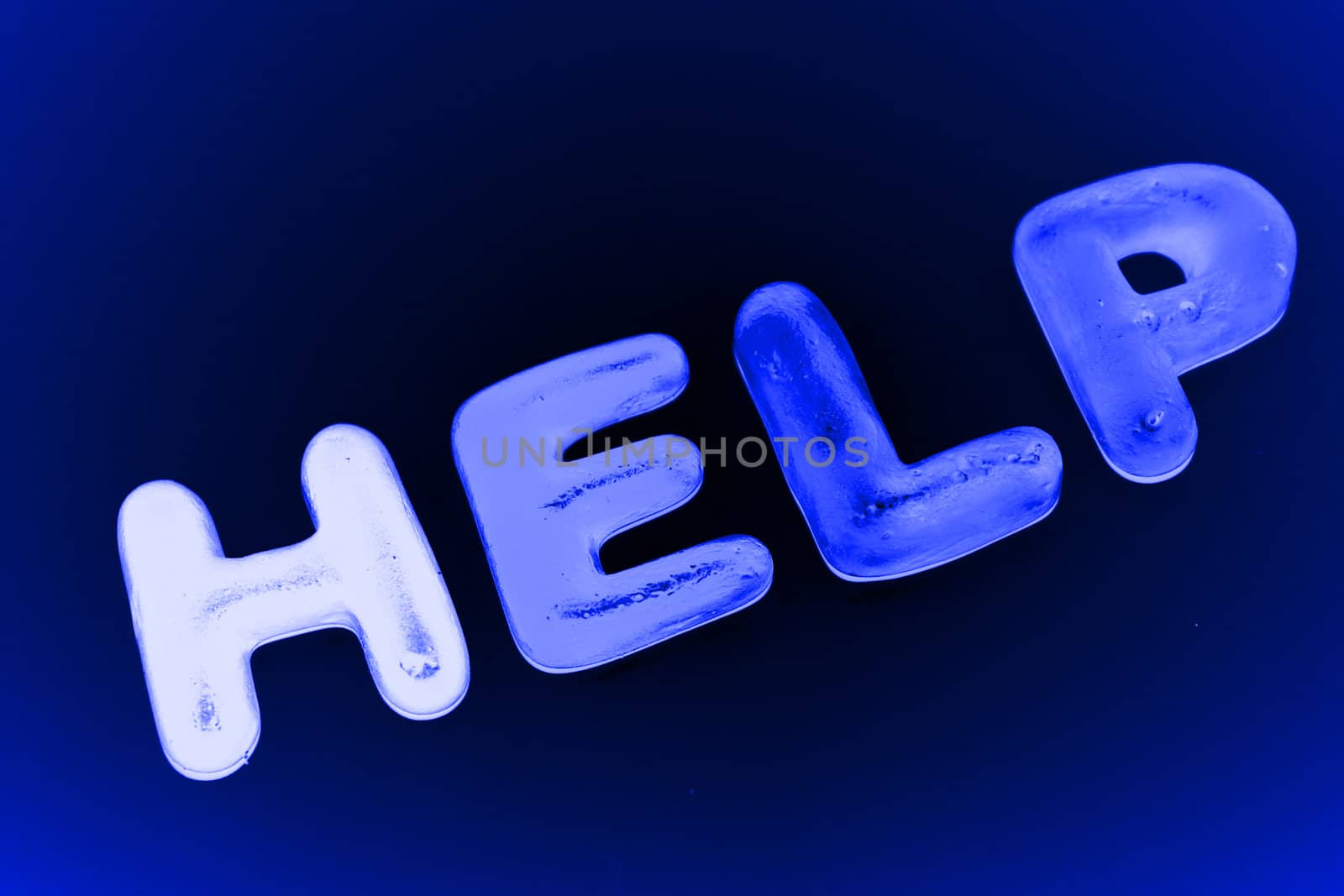 the word help spelt with jelly sweets in blue