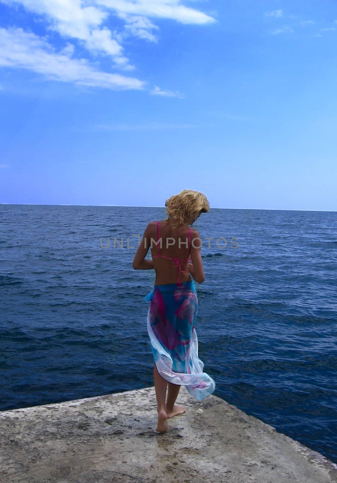 beautiful woman walking in the sea water