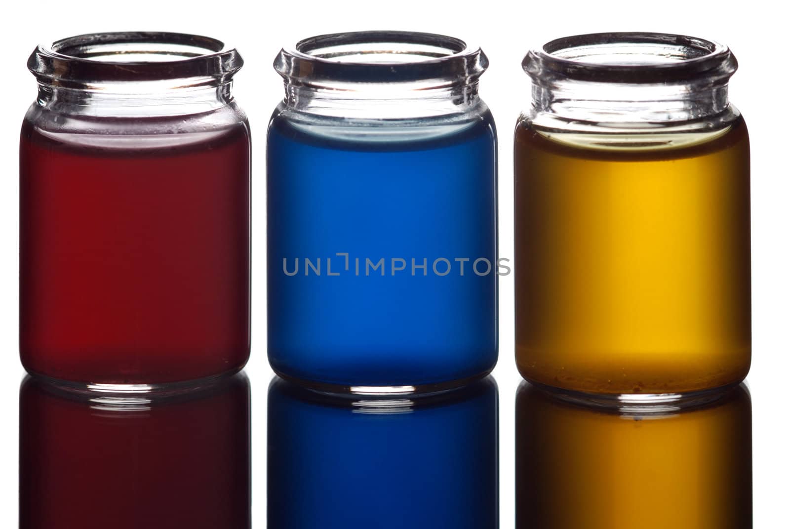 Three glasses filled with colorful liquid isolated on white