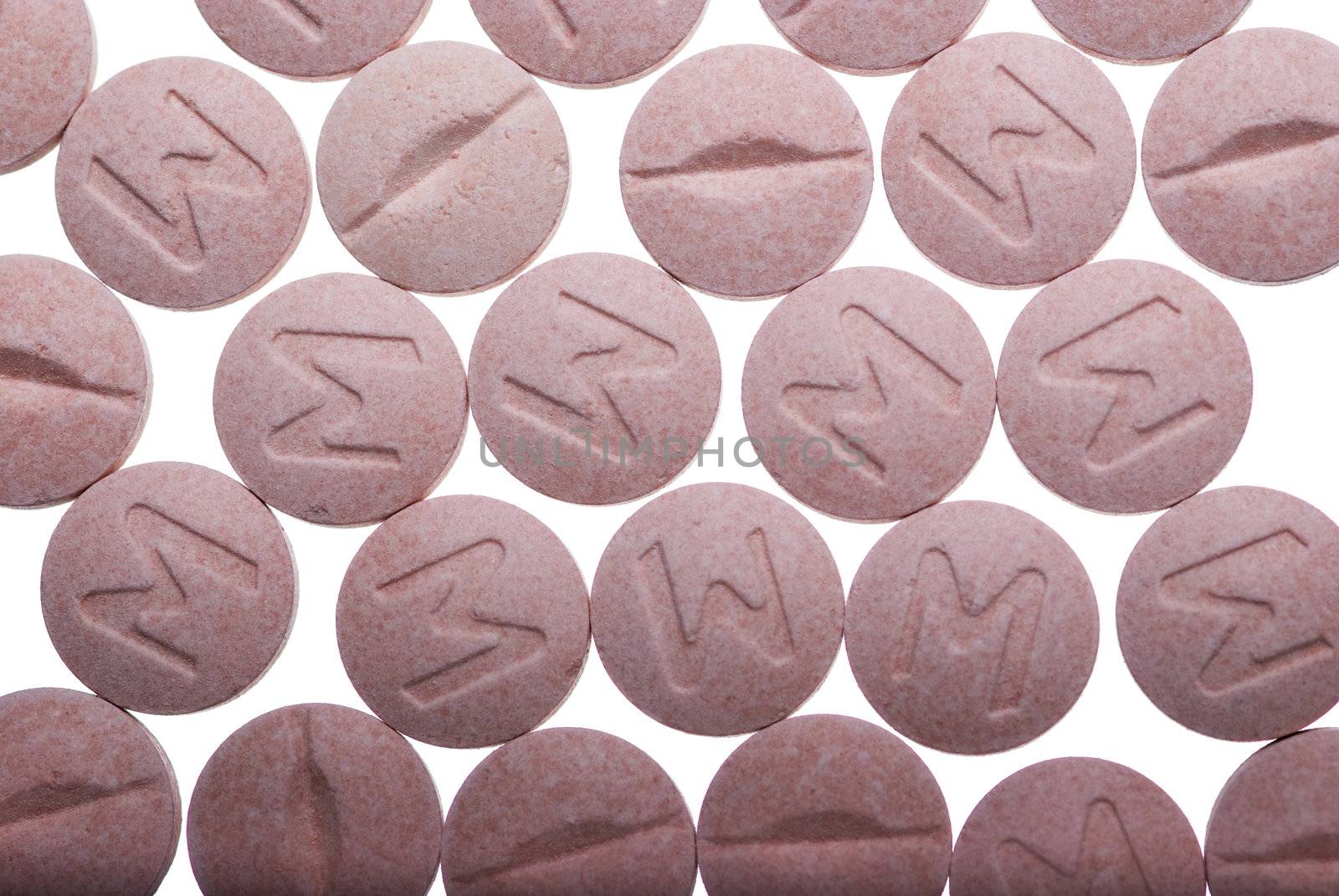 Group of pink pills on white background