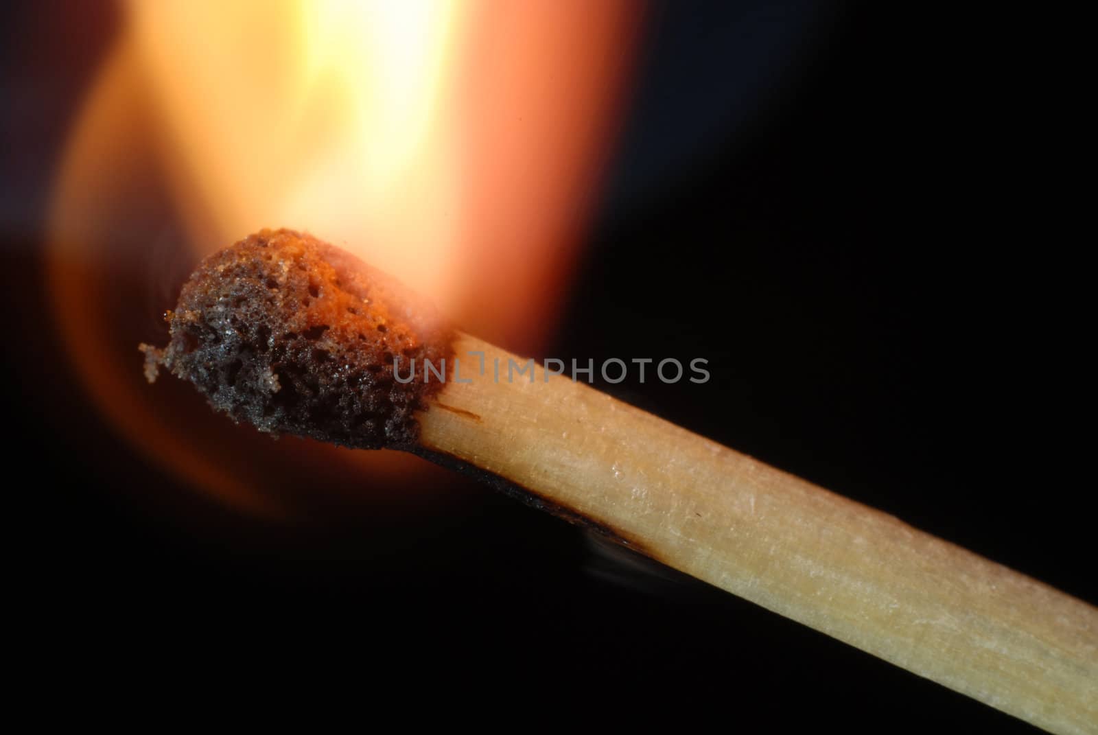 Close-up of igniting match isolated on black