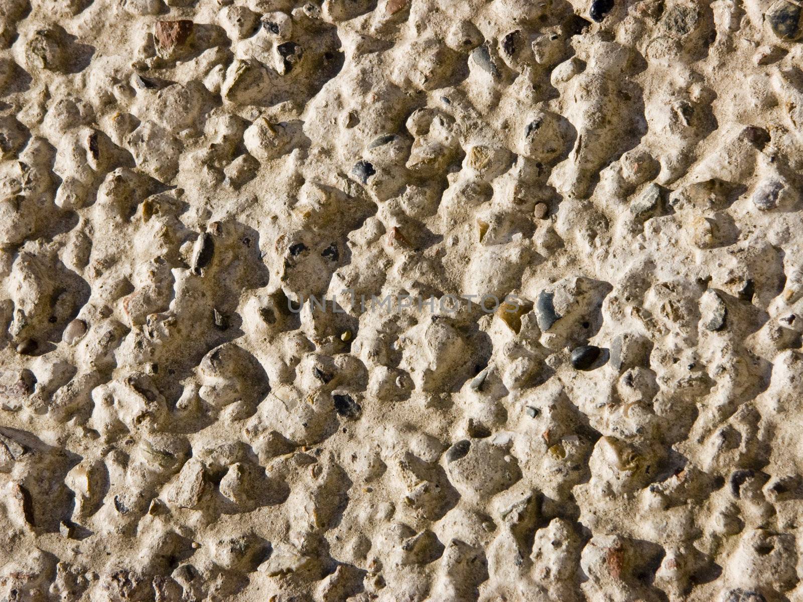 The image of the stones which are sticking out from concrete
