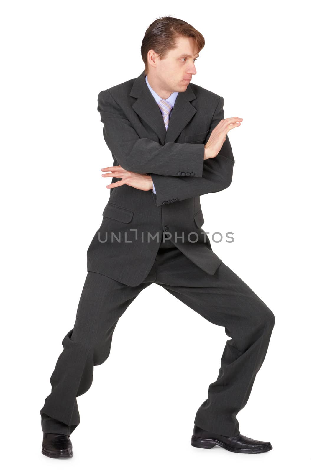 Businessman showing karate skills, isolated on a white background