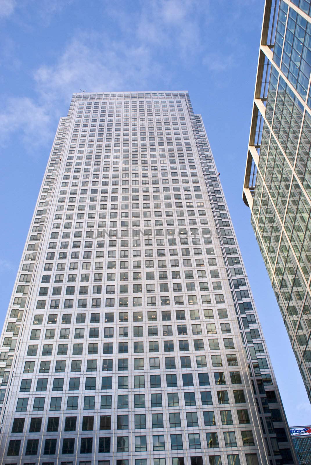 Two skyscrapers against the blue sky with clouds  by fcarucci